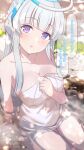  1girl blue_archive blush breasts cleavage collarbone halo highres large_breasts long_hair looking_at_viewer naked_towel noa_(blue_archive) onsen open_mouth partially_submerged purple_eyes shiitake_taishi sitting solo speech_bubble towel translation_request water white_hair white_towel 