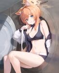  1girl absurdres animal_ears black_sports_bra blue_archive blue_eyes blush breasts cleavage closed_mouth halo highres jacket large_breasts long_hair long_sleeves mari_(blue_archive) mari_(track)_(blue_archive) navel official_alternate_costume orange_hair setakman solo sports_bra track_jacket twitter_username washing_machine yellow_halo 