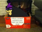  ambiguous_gender black_body black_fur bodily_fluids box clothing container dumb feral fireplace fur hat headgear headwear humor low_res mammal mustelid otter overweight purple_eyes roffa roffauwu solo tears witch_hat yellow_body yellow_fur 
