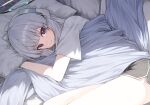  1girl black_shorts blue_archive blunt_bangs closed_mouth commentary dolphin_shorts gnns halo headgear highres long_hair looking_at_viewer lying mechanical_halo noa_(blue_archive) on_bed on_side purple_eyes shirt short_sleeves shorts smile solo thighs under_covers white_hair white_halo white_shirt 