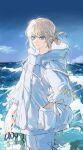  1boy absurdres androgynous blue_eyes blue_sky closed_mouth coat eyelashes fate/grand_order fate_(series) fingernails hand_in_pocket highres holding holding_shoes hood hood_down hooded_coat long_sleeves male_focus oberon_(fate) ocean outdoors shoes shorts sky smile solo water_drop wet white_coat white_shorts yurumawari 
