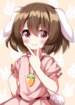 1girl animal_ears brown_hair carrot_necklace closed_mouth dress hand_up highres inaba_tewi jewelry looking_at_viewer necklace pink_background pink_dress pink_eyes rabbit_ears ruu_(tksymkw) short_hair simple_background smile solo touhou v-shaped_eyebrows 