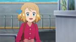  1girl :d backpack bag blonde_hair blue_eyes blue_ribbon blush bow brown_bag buttons collared_dress day dress eyelashes hair_ribbon happy mixed-language_commentary noelia_ponce open_mouth outdoors pink_bow pink_dress pokemon pokemon_(anime) pokemon_xy_(anime) ribbon serena_(pokemon) short_hair smile solo tongue watermark 