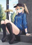  1girl ahoge artoria_pendragon_(fate) baseball_cap black_footwear black_headwear black_shorts blonde_hair blue_jacket blue_scarf boots breasts cross-laced_footwear cross_(crossryou) day fate/grand_order fate_(series) green_eyes hair_between_eyes hair_through_headwear hat highres himitsucalibur_(fate) jacket long_hair looking_at_viewer mysterious_heroine_x_(fate) outdoors ponytail scarf short_shorts shorts sidelocks sitting small_breasts solo track_jacket tree 