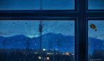  antenna_mast artist_name blurry blurry_background bokeh commentary dated depth_of_field highres indoors jiachen_xu mountain night no_humans original rain scenery sticker transmission_tower water_drop window 