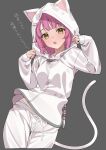  1girl absurdres animal_hood blunt_bangs blush breasts cat_hood cat_tail grey_background highres hood hoodie kawai_ritsu_(rits_meg) long_sleeves looking_at_viewer love_live! love_live!_nijigasaki_high_school_idol_club medium_breasts medium_hair open_mouth pants pink_hair solo tail tennouji_rina translation_request upper_body white_hoodie white_pants yellow_eyes 