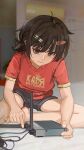  1girl barefoot black_hair blurry blurry_background brown_eyes cable closed_mouth commentary depth_of_field grey_shorts hair_ornament hairclip highres looking_at_object loose_hair_strand messy_hair on_floor original radio_antenna red_shirt router russian_commentary russian_text servachok shirt short_hair short_shorts shorts sitting solo t-shirt tanya_(servachok) thick_eyebrows translated wavy_mouth 