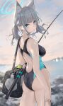  1girl animal_ear_fluff animal_ears ass back bag bare_shoulders blue_archive blue_eyes blue_one-piece_swimsuit blush breasts cross_hair_ornament dema_hmw duffel_bag extra_ears fishing_rod grey_hair grey_sky hair_ornament halo highleg highleg_swimsuit highres looking_at_viewer looking_back medium_breasts medium_hair multicolored_clothes multicolored_swimsuit one-piece_swimsuit shiroko_(blue_archive) shiroko_(swimsuit)_(blue_archive) short_ponytail sidelocks sky solo swimsuit thighs wet wolf_ears 