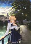  1girl adapted_costume ahoge artoria_pendragon_(fate) bench blonde_hair blue_bow blue_bowtie blue_skirt bow bowtie braid building cloud day fate/stay_night fate_(series) french_braid grass green_eyes hair_bow hand_on_own_chest hand_on_railing highres lamppost looking_at_viewer outdoors park park_bench railing saber shirt skirt sky smile solo takeuchi_takashi trash_can tree water white_shirt 