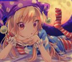  1girl american_flag_dress american_flag_legwear blonde_hair clownpiece hat jester_cap long_hair looking_at_viewer lying moon on_stomach polka_dot polka_dot_headwear solo takahashi_kouta touhou wrist_cuffs 