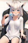  1girl ahoge animal_ear_fluff animal_ears black_shorts blurry blurry_background blush braid chair collarbone commentary_request earrings fang food fox_ears fox_girl gaming_chair green_eyes hair_between_eyes highres holding holding_food holding_popsicle hololive jewelry long_hair looking_at_viewer open_mouth popsicle shirai_yu shirakami_fubuki shirt short_sleeves shorts sidelocks single_braid sitting skin_fang solo swivel_chair virtual_youtuber white_hair white_shirt 