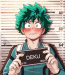  1boy athena_av barbie_mugshot_(meme) bite_mark blush bodysuit boku_no_hero_academia english_commentary english_text freckles gloves green_bodysuit green_eyes green_hair height_chart height_mark highres holding holding_sign male_focus meme midoriya_izuku mugshot nervous sign solo spiked_hair superhero sweat white_gloves 