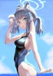  1girl absurdres animal_ear_fluff animal_ears black_one-piece_swimsuit blue_archive blue_eyes blue_sky breasts cloud competition_swimsuit covered_navel cowboy_shot cross_hair_ornament day extra_ears grey_hair hair_ornament halo highres horizon kaifiya looking_at_viewer low_ponytail medium_breasts medium_hair mismatched_pupils multicolored_clothes multicolored_swimsuit ocean official_alternate_costume one-piece_swimsuit outdoors shiroko_(blue_archive) shiroko_(swimsuit)_(blue_archive) sky solo swimsuit towel wolf_ears 