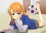  1girl :t ball barefoot blue_jacket blurry blurry_background blush brown_shorts commentary_request depth_of_field eyelashes feet feet_up full_body grey_shirt hand_up head_rest highres holding_with_feet idolmaster idolmaster_cinderella_girls indoors jacket legs long_hair long_sleeves lying makaizou_(yawo87) manga_(object) on_stomach orange_hair pink_eyes reading shiny_skin shirt shorts soccer_ball soles solo swept_bangs the_pose thighs toes uneven_eyes yuuki_haru 