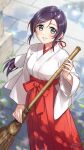  1girl absurdres blurry blurry_background broom dated green_eyes hakama hakama_skirt highres holding holding_broom japanese_clothes kimono long_hair love_live! love_live!_school_idol_project low_ponytail miko outdoors purple_hair red_hakama signature skirt solo swept_bangs toujou_nozomi wedo white_kimono 