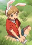  1boy animal_ears bishounen commentary_request day denim denim_shorts fake_animal_ears full_body hand_on_own_foot highres looking_at_viewer male_focus on_grass original outdoors rabbit_ears red_hood shirt short_hair shorts sitting socks solo teeth upper_teeth_only white_shirt white_socks zipper_pull_tab 