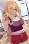  1girl absurdres bare_shoulders blonde_hair blush breasts cleavage collarbone cup genshin_impact gym hair_between_eyes hair_ornament highres holding holding_cup holding_phone large_breasts looking_at_viewer lumine_(genshin_impact) navel o-los phone shirt short_hair_with_long_locks shorts sidelocks smile solo sweat yellow_eyes 