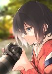  1girl black_hair blue_eyes blurry blurry_background camera close-up closed_mouth highres holding holding_camera jacket jjjehuty koe_no_katachi nishimiya_yuzuru outdoors red_jacket reverse_trap short_hair solo sweat track_jacket 