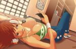  1girl artist_name bikini book brown_eyes cellphone character_name denim green_bikini headphones jeans jolly_roger leomezamx long_hair lying midriff nami_(one_piece) one_piece open_mouth orange_hair pants phone smartphone swimsuit television wanted 