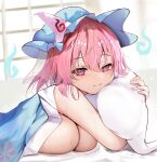  1girl blue_headwear bob_cut breasts cleavage closed_mouth efe hair_between_eyes hat highres hitodama huge_breasts looking_at_viewer lying mob_cap object_hug on_bed on_stomach pillow pillow_hug pink_eyes pink_hair saigyouji_yuyuko smile solo sweat touhou triangular_headpiece under_covers 