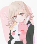  1girl :d black_jacket blush bow closed_mouth danganronpa_(series) danganronpa_2:_goodbye_despair ear_bow galaga hair_ornament heart highres holding hug jacket kori_ha long_sleeves looking_at_viewer medium_hair monomi_(danganronpa) nanami_chiaki open_mouth pink_background pink_eyes sleeves_past_wrists smile solo white_background yellow_bow 