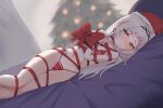  1girl bikini blush bound bound_arms bound_legs bow cameltoe christmas closed_mouth ear_blush feet_out_of_frame grey_hair hat highres hololive kusa_mori long_hair looking_at_viewer lying murasaki_shion navel nose_blush on_side red_bikini red_bow red_headwear red_ribbon ribbon santa_hat side-tie_bikini_bottom solo swimsuit virtual_youtuber yellow_eyes 