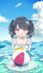  1girl absurdres ball beachball bead_necklace beads black_hair blue_flower blue_sky blush bow cloud collarbone crab day dot_nose fangs flower fukumaru_koito green_one-piece_swimsuit hair_bow hair_ornament highres holding holding_ball holding_beachball idolmaster in_water jewelry looking_at_viewer necklace ocean one-piece_swimsuit open_mouth outdoors pink_flower polka_dot polka_dot_swimsuit purple_eyes see-through see-through_sleeves shell skin_fangs sky solo star_(symbol) star_hair_ornament suyaya_oyasumi swimsuit twintails 