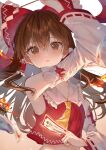  1girl bare_shoulders blush brown_eyes brown_hair commentary_request detached_sleeves fire frilled_ribbon frills gohei hair_ribbon hakurei_reimu highres holding holding_gohei long_hair looking_at_viewer luna_(luna610) midriff nontraditional_miko open_mouth red_ribbon red_shirt ribbon shirt solo talisman touhou white_background wide_sleeves 