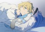  1boy blanket blonde_hair blue_eyes closed_mouth ferret hair_between_eyes hiyamaru holding holding_phone holostars kishido_temma looking_at_phone lying male_focus on_bed on_stomach pajamas phone pillow saku_(sakudeji) shirt short_hair solo under_covers upper_body virtual_youtuber white_pajamas white_shirt 