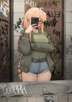  1girl absurdres ahoge belt blonde_hair blue_eyes blush braid braided_ponytail breasts bright_pupils cellphone denim denim_shorts glass glasses green_jacket green_shirt highres holding holding_phone indie_virtual_youtuber indoors jacket long_hair long_sleeves looking_at_viewer medium_breasts mirror phone reflection restroom selfie shirt shorts smartphone solo very_long_hair virtual_youtuber whiskey_project white_pupils xerbatt 