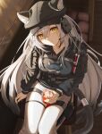  1girl animal_ears arknights closed_mouth collarbone cup hat headphones holding holding_cup ice jacket leopard_ears leopard_girl leopard_tail long_hair long_sleeves looking_at_viewer pants schwarz_(arknights) shironekoban sitting solo tail white_hair yellow_eyes 