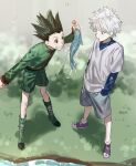  2boys absurdres black_hair blue_eyes boots brown_eyes chamuring child fish fishing_rod gon_freecss green_footwear green_jacket grey_shorts hands_in_pockets highres hunter_x_hunter jacket killua_zoldyck layered_sleeves long_sleeves looking_at_another male_focus multiple_boys open_mouth outdoors purple_footwear shirt short_hair short_over_long_sleeves short_sleeves shorts smile spiked_hair white_hair white_shirt 