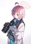  1girl absurdres ahoge blue_archive blue_eyes blush camera camera_around_neck closed_mouth coat hair_between_eyes halo headphones headphones_around_neck heterochromia highres hishiki_(pixi14719710) holding holding_camera hoshino_(blue_archive) hoshino_(young)_(blue_archive) pink_hair pink_halo short_hair simple_background sleeves_past_wrists solo white_background white_coat yellow_eyes 