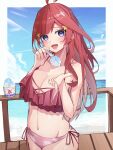  1girl absurdres ahoge bare_arms bare_shoulders bikini blue_eyes blush border breasts cleavage collarbone cowboy_shot food gakkunning go-toubun_no_hanayome hair_ornament highres holding holding_spoon incoming_food large_breasts long_hair looking_at_viewer nakano_itsuki navel ocean open_mouth outside_border red_bikini red_hair shaved_ice side-tie_bikini_bottom sky solo spoon star_(symbol) star_hair_ornament swimsuit white_border 