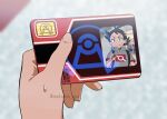  1boy barcode blurry blurry_background card commentary_request day goh_(pokemon) holding holding_card id_card male_focus matsuno_opa outdoors poke_ball_print pokemon pokemon:_destiny_deoxys pokemon_(anime) pokemon_journeys pokemon_rse_(anime) solo sweatdrop twitter_username watermark 