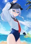  1girl absurdres alternate_hairstyle anchor_symbol beach black_sailor_collar blue_eyes blue_one-piece_swimsuit commentary_request day flat_cap grey_hair hat hibiki_(kancolle) highres kantai_collection long_hair neckerchief ocean one-piece_swimsuit ponytail red_neckerchief sailor_collar sand school_swimsuit school_uniform serafuku solo swimsuit swimsuit_under_clothes water water_gun yoshino_(mfmfpng) 
