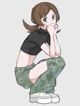  1girl alternate_costume black_shirt brown_eyes brown_hair closed_mouth clothing_cutout commentary_request cropped_shirt from_side full_body green_pants grey_background hands_up highres kana_(kanna_runa0620) long_hair looking_at_viewer lyra_(pokemon) pants platform_footwear pokemon pokemon_(game) pokemon_hgss shirt shoes short_sleeves solo squatting thigh_cutout twintails 