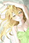  1girl arm_up bare_shoulders bed_sheet blonde_hair blush breasts cleavage collarbone commentary_request dress green_dress green_eyes hair_between_eyes haruri highres hoshii_miki idolmaster long_hair looking_at_viewer lying on_back signature small_breasts smile solo 