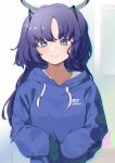  1girl absurdres blue_archive blue_eyes blue_hoodie clothes_writing halo highres hood hoodie long_hair long_sleeves looking_at_viewer mechanical_halo nakare2845 puffy_long_sleeves puffy_sleeves purple_hair sleeves_past_fingers sleeves_past_wrists solo two_side_up upper_body yuuka_(blue_archive) 