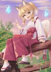  1girl :d animal_ear_fluff animal_ears bell blonde_hair brown_eyes brown_footwear cloud cloudy_sky fang fence fox_ears fox_girl fox_shadow_puppet fox_tail hair_bell hair_between_eyes hair_ornament hakama hakama_pants hitodama japanese_clothes jingle_bell kimono long_sleeves looking_at_viewer miko miri_(ago550421) on_fence original outdoors pants ponytail red_hakama red_pants ribbon-trimmed_sleeves ribbon_trim shoe_soles short_eyebrows sidelocks sitting sitting_on_fence sky smile socks solo tabi tail thick_eyebrows white_kimono white_socks 