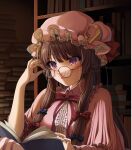  1girl adjusting_eyewear bespectacled book bookshelf bow commentary_request crescent crescent_hat_ornament emoriza glasses hair_bow hat hat_ornament highres mob_cap patchouli_knowledge purple_eyes purple_hair reading sidelocks signature solo touhou 