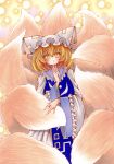  1girl absurdres animal_ears animal_hat blonde_hair blue_tabard blush commentary fox_tail hat highres kitsune long_sleeves looking_at_viewer medium_hair mob_cap multiple_tails open_mouth slit_pupils solo tabard tail touhou wide_sleeves yakumo_ran yellow_eyes yuuki_hana_(jtnp5334) 