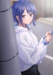  1girl absurdres akira_(jitsuimo) black_pants blue_hair blurry blurry_background blush cellphone chigusa_minori commentary_request highres holding holding_phone hood hoodie jitsu_wa_imouto_deshita. long_sleeves looking_at_viewer looking_to_the_side outdoors pants parted_lips phone purple_eyes second-party_source short_hair smartphone solo utility_pole white_hoodie 