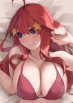  1girl ahoge amog bed bikini blue_eyes blush breasts cleavage collarbone embarrassed go-toubun_no_hanayome hair_ornament highres huge_breasts large_breasts long_hair looking_to_the_side lying nakano_itsuki on_back on_bed red_bikini red_hair star_(symbol) star_hair_ornament swimsuit 