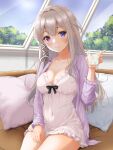  1girl absurdres alcohol azur_lane blonde_hair blue_eyes blush breasts ca_paria cleavage collarbone commentary_request couch covered_navel cup frills hand_up heterochromia highres holding holding_cup indoors jacket large_breasts long_hair long_sleeves looking_at_viewer murmansk_(azur_lane) murmansk_(sceneries_of_pure_snow)_(azur_lane) nightgown official_alternate_costume open_clothes open_jacket pillow purple_eyes purple_jacket sitting smile solo tree vodka white_nightgown window 