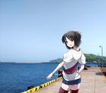  1girl alternate_costume belt_bag black_hair black_thighhighs blue_shorts blue_sky brown_eyes cloud cowboy_shot day denim denim_shorts dock from_behind horizon kantai_collection kimura_shiki looking_at_viewer looking_back mountain nagara_(kancolle) ocean one_side_up outdoors photo_background shirt short_hair shorts sky solo standing t-shirt thighhighs water white_shirt 