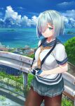  001machi 1girl black_pantyhose blue_eyes blush breasts building camera cloud cloudy_sky cowboy_shot day gloves grey_hair grey_skirt hair_ornament hair_over_one_eye hairclip hamakaze_(kancolle) highres house kantai_collection large_breasts looking_at_viewer mountain neckerchief ocean outdoors pantyhose pleated_skirt road scenery school_uniform serafuku short_hair short_sleeves skirt sky smile solo town white_gloves yellow_neckerchief 