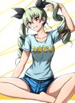  1girl anchovy_(girls_und_panzer) barefoot black_ribbon blue_shirt blue_shorts clothes_writing commentary denim denim_shorts drill_hair girls_und_panzer green_hair grin hair_ribbon hand_in_own_hair head_tilt highres indian_style long_hair looking_at_viewer loungewear omachi_(slabco) ribbon shirt short_shorts short_sleeves shorts sitting smile solo t-shirt twin_drills twintails 