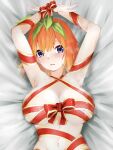  1girl armpits arms_up bed_sheet blue_eyes blush breasts from_above gift_wrapping go-toubun_no_hanayome green_ribbon hair_ribbon highres large_breasts looking_at_viewer lying nakano_yotsuba navel on_back orange_hair parted_lips ribbon short_hair solo upper_body wai_(y48754085) wrapped_up 