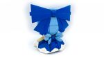  1girl blue_bow blue_dress blue_hair bow cirno commentary dress english_commentary facing_away fairy_wings from_behind full_body fumo_(doll) hair_bow highres lavishlump lego_(medium) light_blue_hair medium_hair short_sleeves simple_background sitting solo touhou white_background wings 